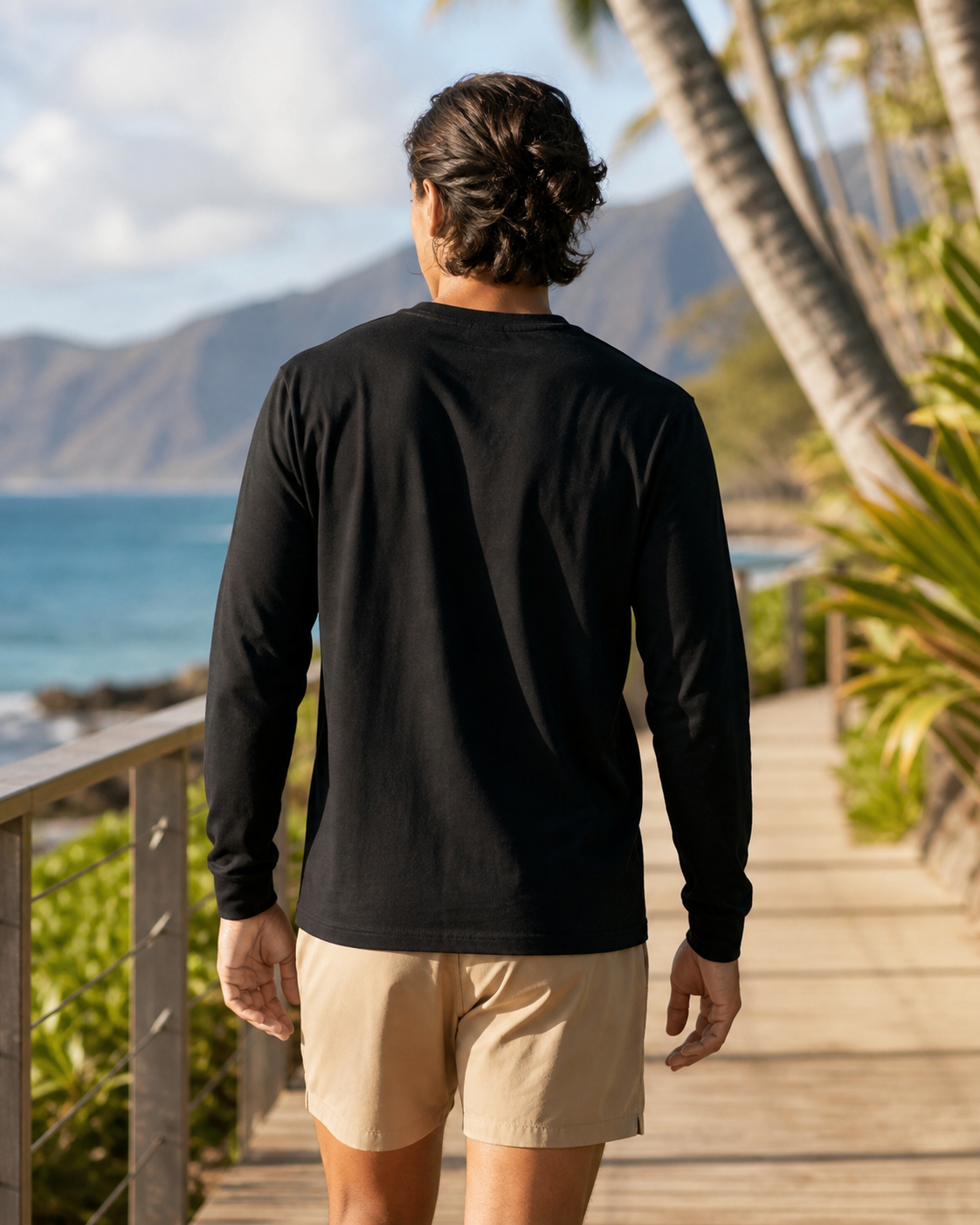 Black organic cotton long sleeve training tee back view on a coastal boardwalk