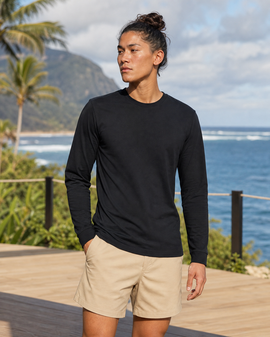 Black organic cotton long sleeve training tee front view on a coastal terrace