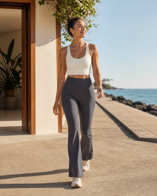 Woman wearing KeAloha Charcoal Athflow Pants on a coastal promenade