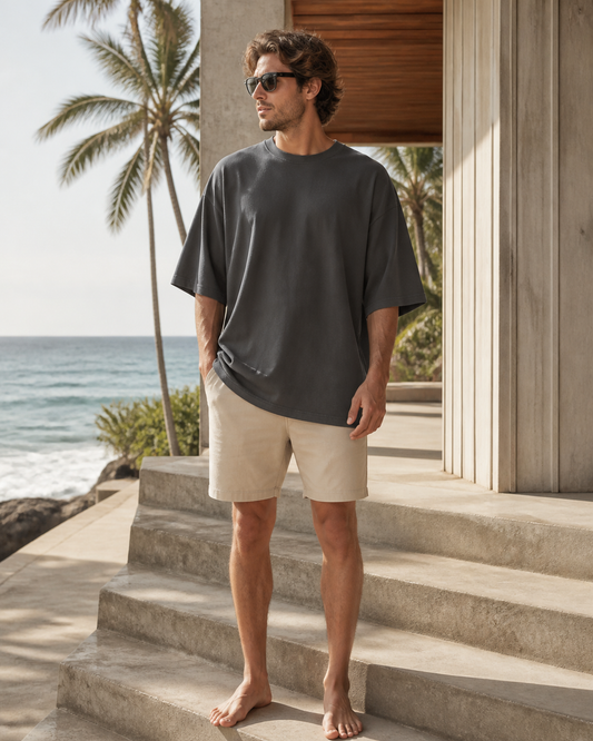 Man wearing the KeAloha Charcoal Classic Oversized Tee at a beach pavilion