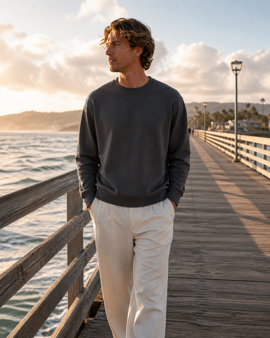 Man wearing the KeAloha Charcoal Crewneck Sweatshirt on a coastal pier