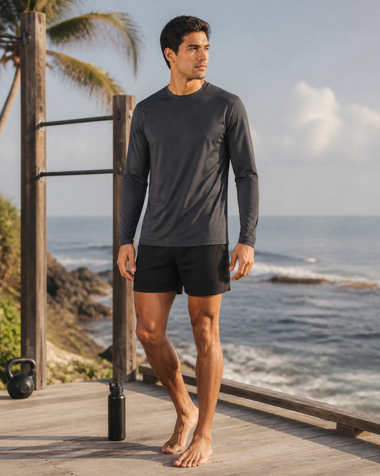 Man wearing the KeAloha Charcoal Long Sleeve Training Tee on an oceanfront training deck