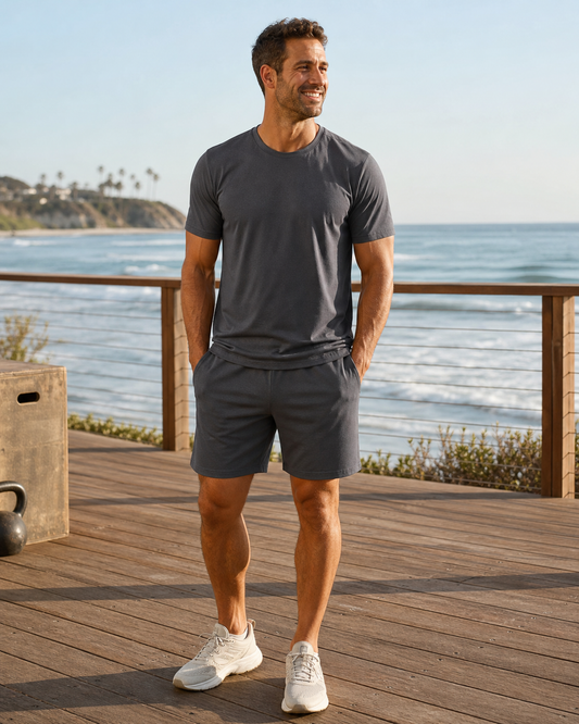 Man wearing the KeAloha Charcoal Men's Matching Set on an oceanfront training deck