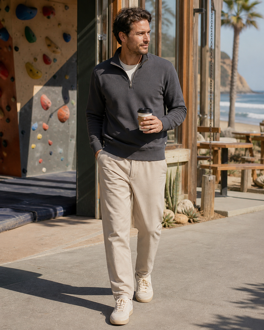 Man wearing the KeAloha Charcoal Quarter-Zip Pullover outside a coastal climbing gym