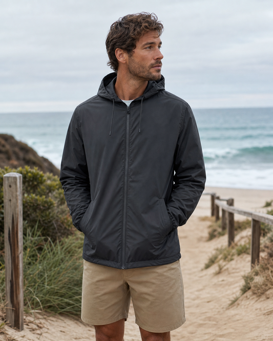 Classic charcoal windbreaker on a breezy beach path