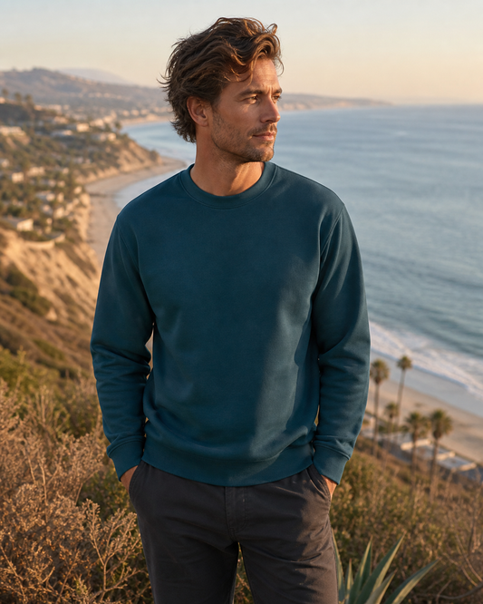 Deep teal organic cotton crewneck sweatshirt at a coastal lookout