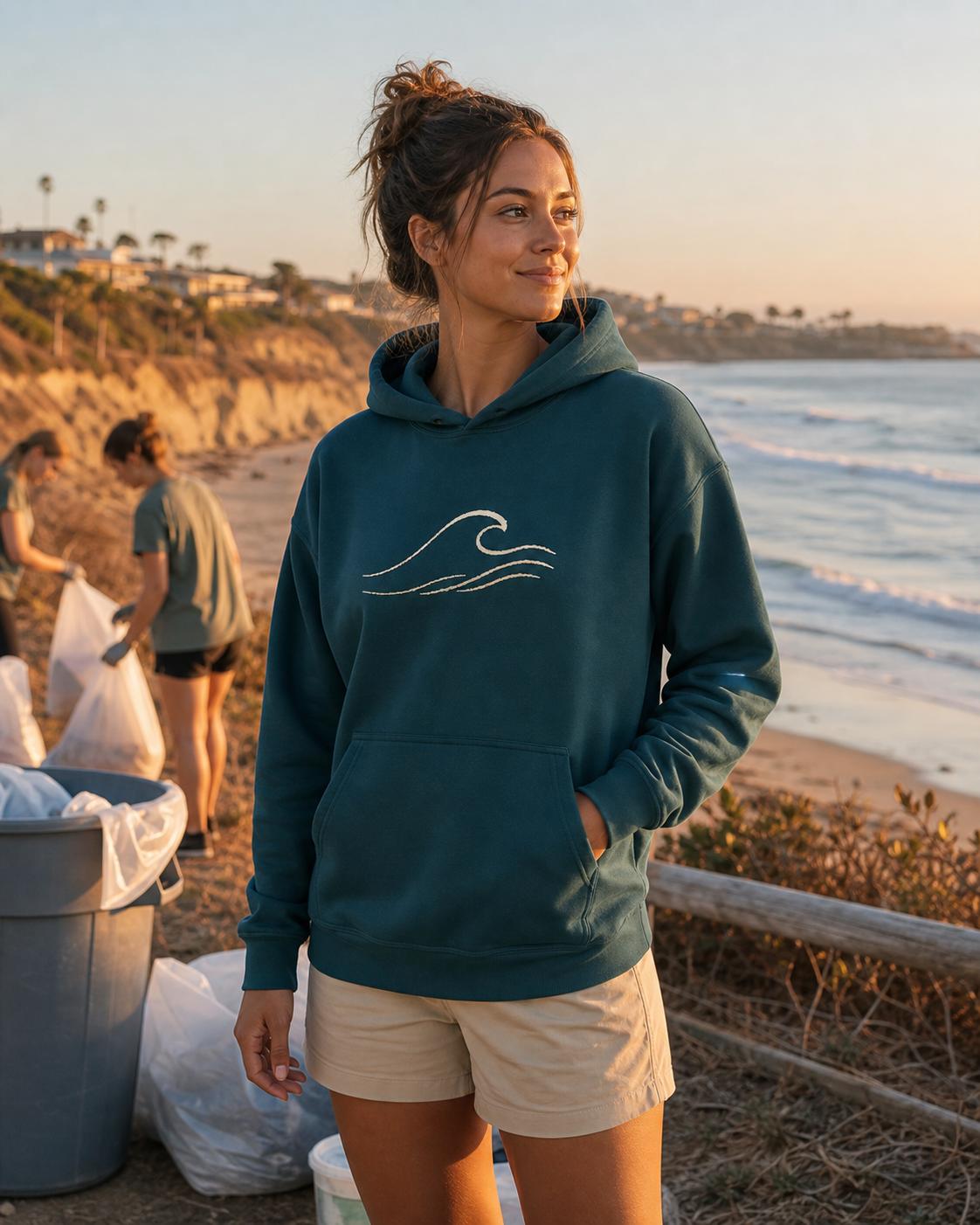 Deep teal graphic pullover hoodie after a community beach cleanup
