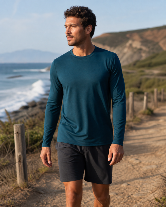 Deep teal long sleeve training tee on a coastal path