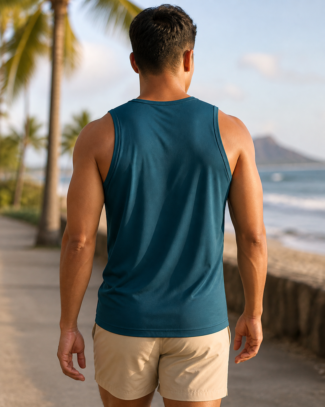 Deep teal recycled fitted running tank back view on a coastal path