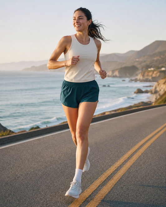 Deep teal unlined running shorts on a coastal road