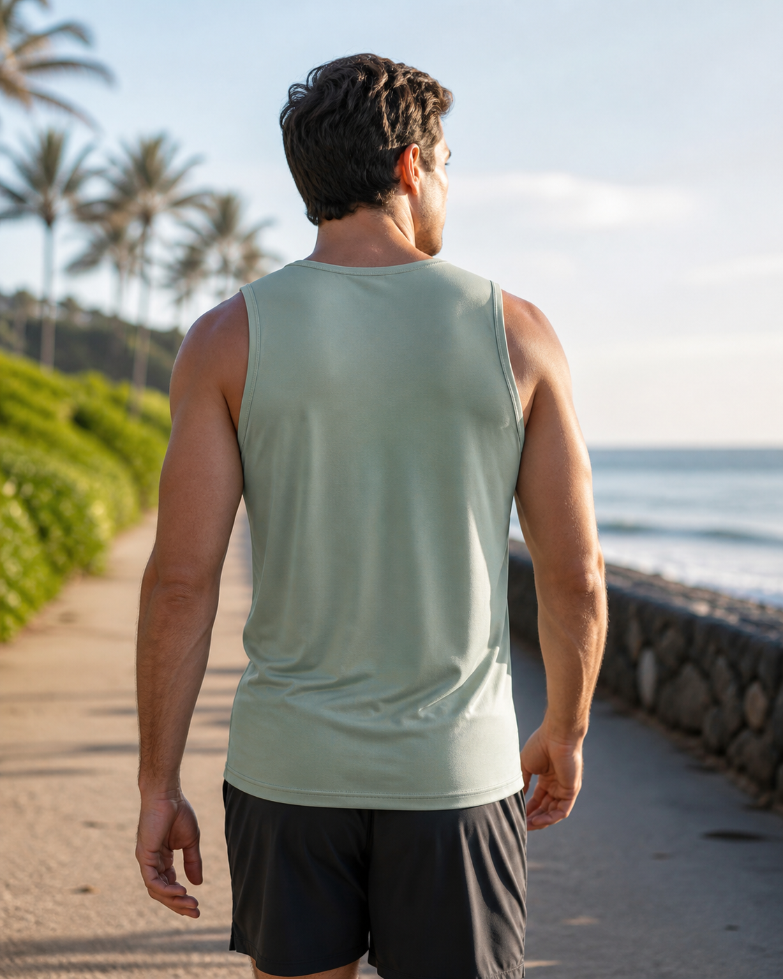 Sage recycled fitted running tank back view on a coastal path