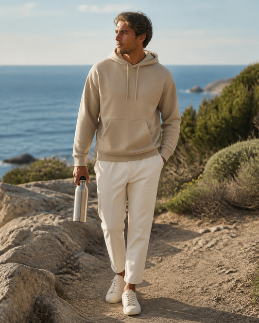 Man wearing a sand recycled-polyester pullover hoodie at a coastal conservation overlook
