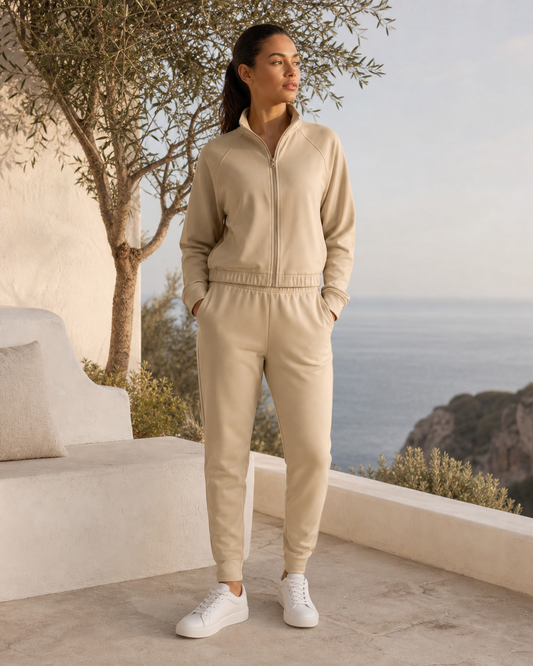 Woman wearing a matching sand tracksuit at a cliffside coastal retreat